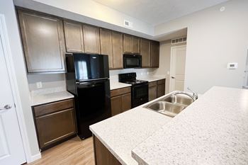 a kitchen with black appliances and white counter tops
